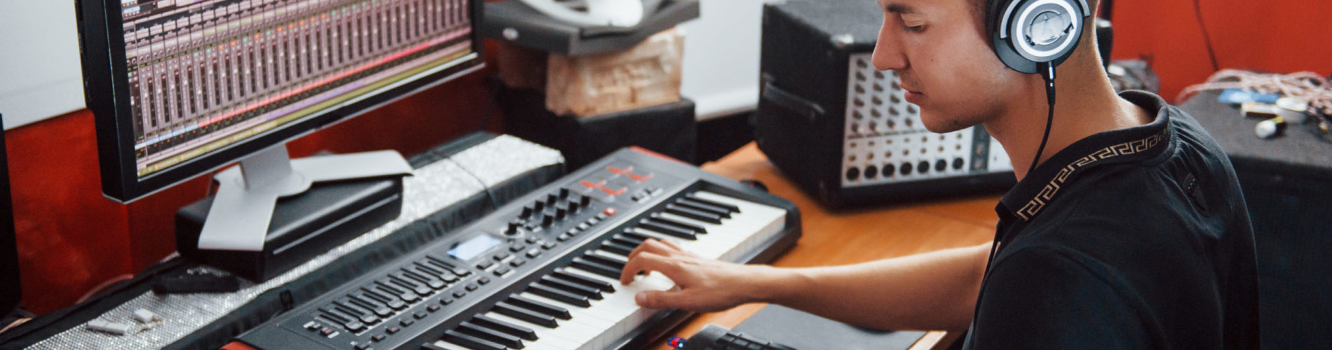 Sound engineer in headphones working and mixing music indoors in the studio