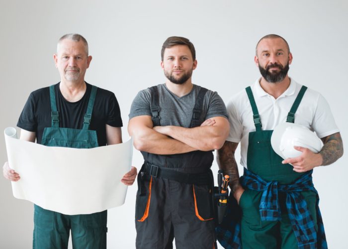 Group of three builders preparing for remodeling of the apartment